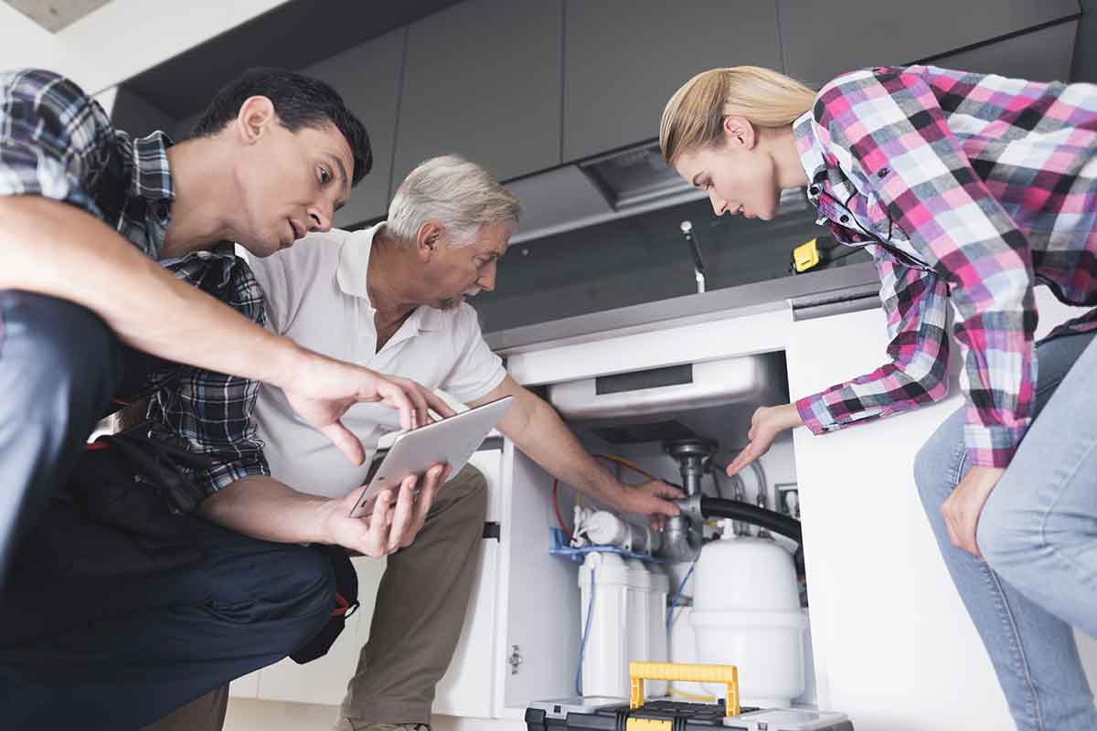 Licensed plumber inspecting water heater in Prosper TX home