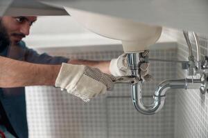Plumber fixing a drain - General Plumbing